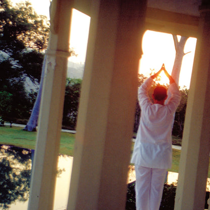 A person practising morning sun salutation in yoga at Ananda in Rishikesh